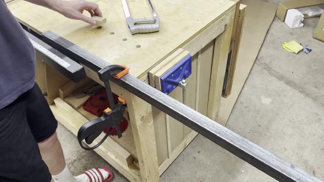 Steel angle clamped to the bench, marked and ready to cut