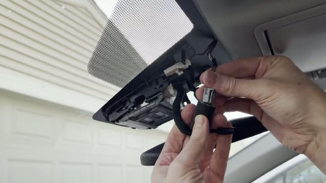 Plugging the FITCAMX wiring harness into the mirror power connector
