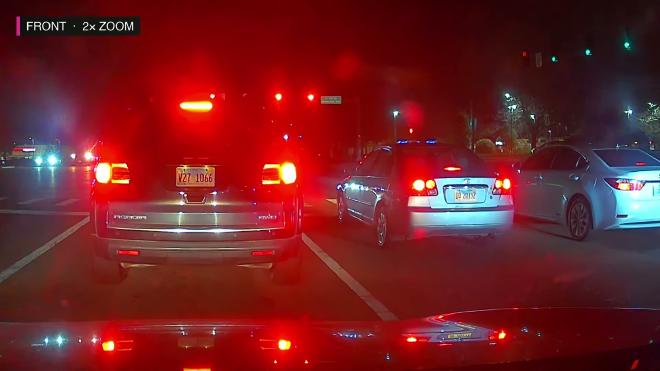 FITCAMX 4K night footage zoomed in on license plates at a red light