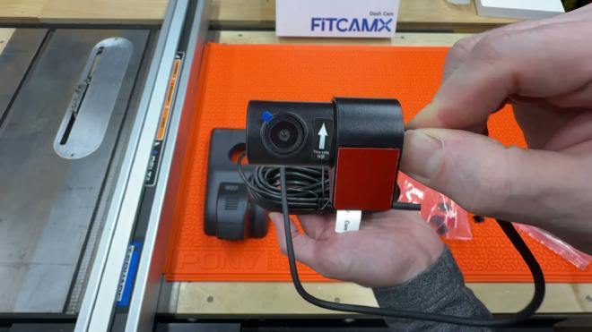 FITCAMX rear camera with the this-side-up label and adhesive pad