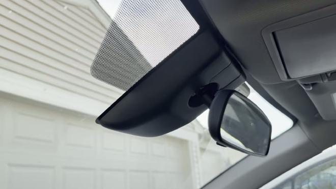 Factory rearview mirror cover on a 2018 Toyota RAV4 before the dash cam install