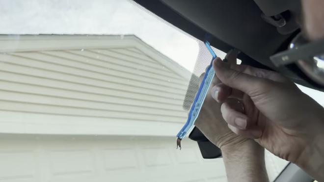 Tucking the rear camera cable under the headliner with the included trim tool