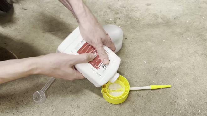 Pouring insecticide dust into a powder duster