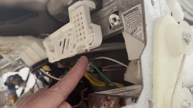 Water dripping from the float switch housing under the Whirlpool dishwasher