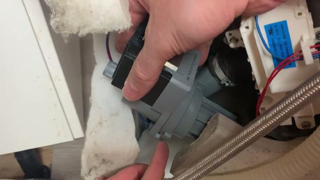 Removing the Whirlpool dishwasher circulation pump from underneath the unit