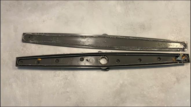 Middle Whirlpool dishwasher spray arm opened for cleaning