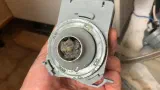 Clogged Whirlpool dishwasher circulation pump removed for cleaning